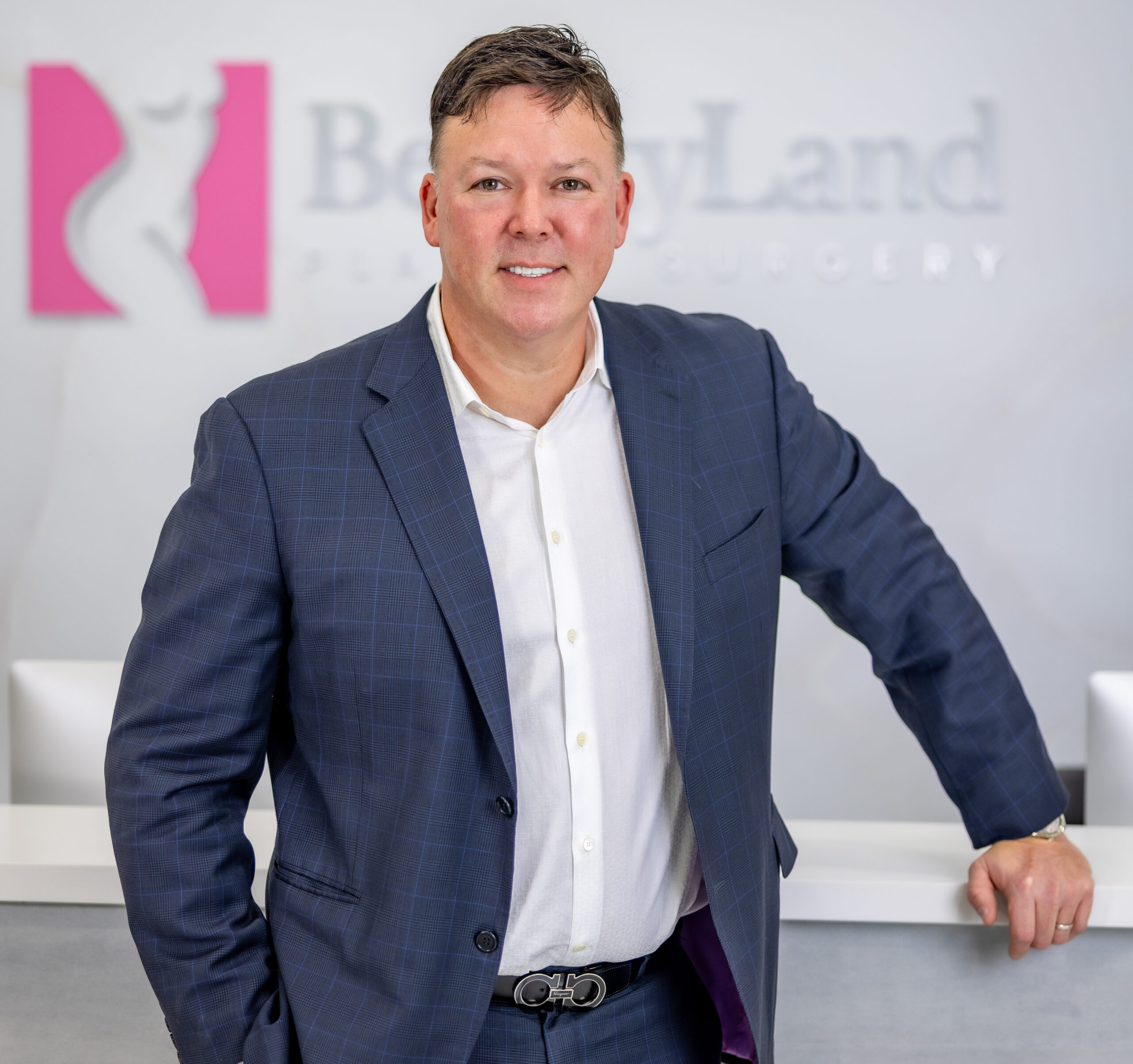 Dr. Oliver Pope Simmons, MD, Plastic and Reconstructive surgeon at BeautyLand Plastic Surgery Miami, is pictured posing smiling for a picture.