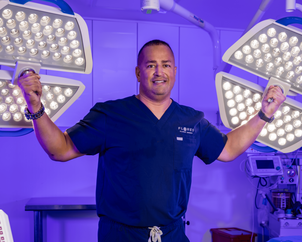Dr. Jaime Flores, MD, surgeon at BeautyLand Plastic Surgery Miami, American Board Certified Plastic surgeon, is pictured posing for a photo with open arms.
